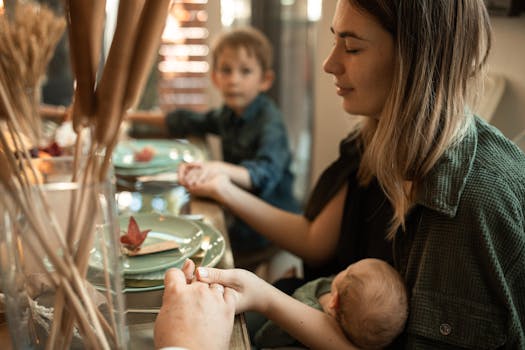 A family gathered indoors sharing a meal and holding hands during Thanksgiving.