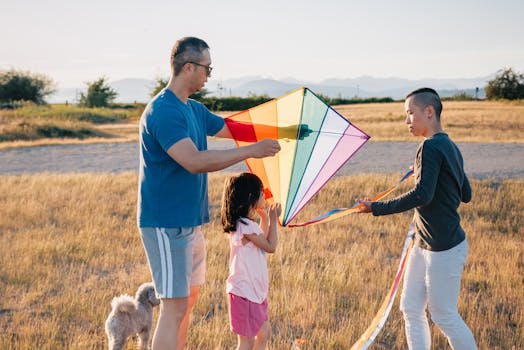 A joyful family flying a colorful kite in a sunny outdoor field, enjoying quality time together.